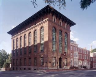 historic brick building with large windows and tower