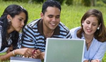 three students with laptop outdoors