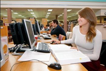 students studying at library computers