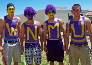 four students with body paint spelling 'wnmu'