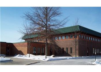 brick building with green roof in winter