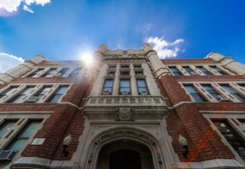 sunshine over historical college building facade