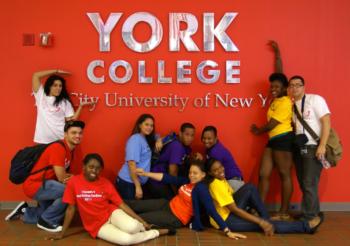 group of students in front of 'york college' wall sign