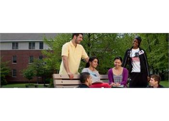 students sitting together outside on campus