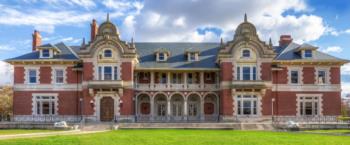 historic building with ornate red brick facade and gables