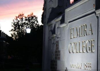 sunset behind 'elmira college' sign and gate