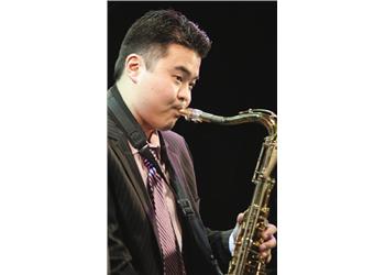 musician playing a saxophone on stage