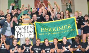 crowd with 'campus pride herkimer' banner and mascot