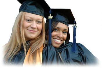 two graduating students smiling in caps and gowns