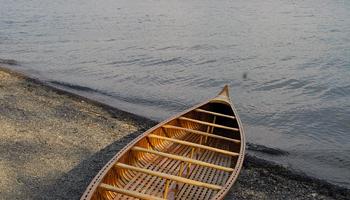 solo canoe on a peaceful lakeshore