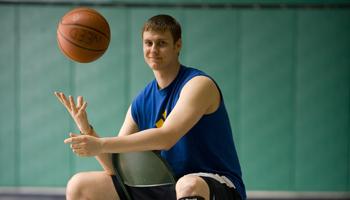 student spinning a basketball on his finger