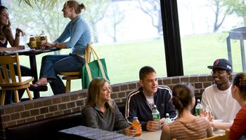 group of students chatting in a dining area