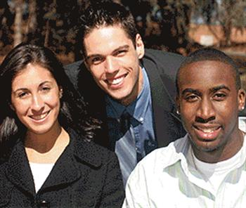 three students smiling and posing together outdoors