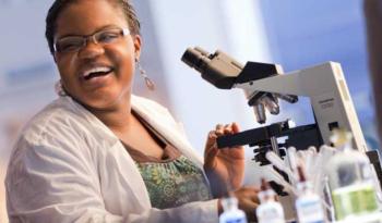 student using a microscope in a laboratory