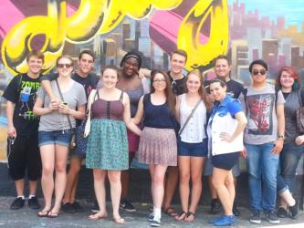 students in front of graffiti wall