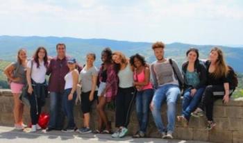 students posing on a hillside