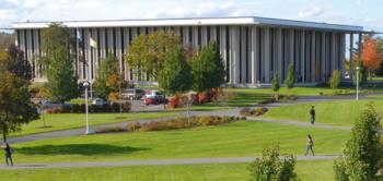 campus building with large windows surrounded by greenery