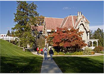 people walking near a historic building on a sunny day