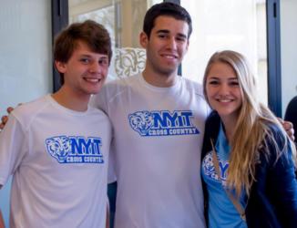 three students in nyit apparel smiling