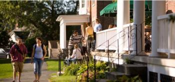 students walking near a building with columns