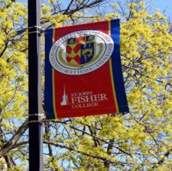 st john fisher college banner among trees