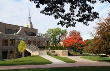 tree-lined campus building with red leaves