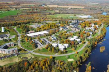 aerial view of a riverside college campus in autumn