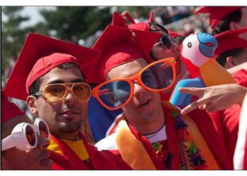 graduates in red caps with large glasses