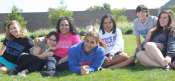 students sitting on grass