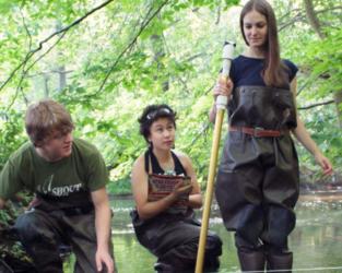 students conducting water research in a stream
