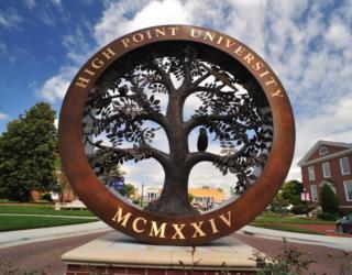 campus landmark with 'high point university mcmxxiv'