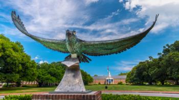 bronze eagle statue with spread wings on campus