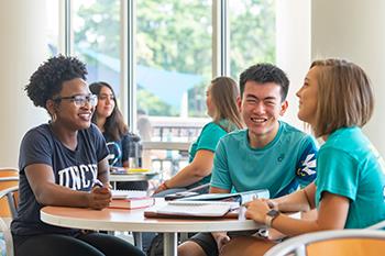 students studying and chatting in campus building