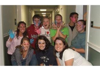 group of students with painted faces smiling