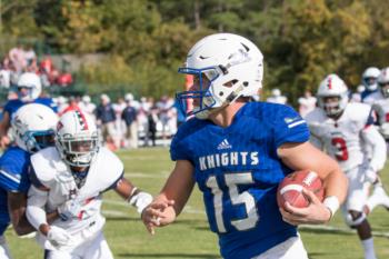 football player running with the ball in game