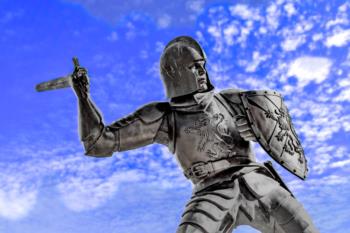 statue of a knight against a blue sky