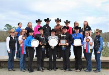 equestrian team with trophies outdoors