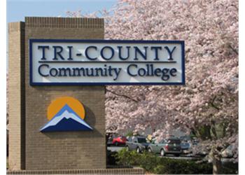 sign 'tri-county community college', blossoms in background