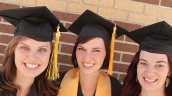 three female graduates smiling