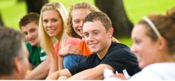 group of students sitting outdoors in a circle