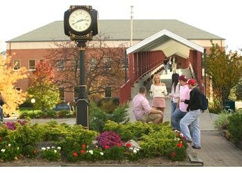 students near clock tower and garden