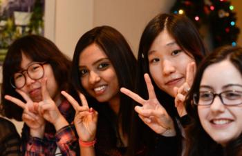 group of smiling students posing with peace signs