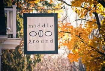 'middle ground' sign among fall foliage