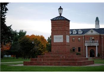 brick building with a sign and lamp post