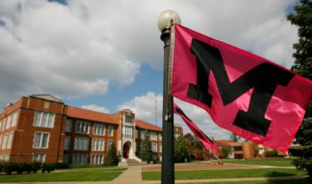 Muskingum University flag in front of building