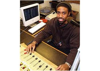 man operating audio mixing console