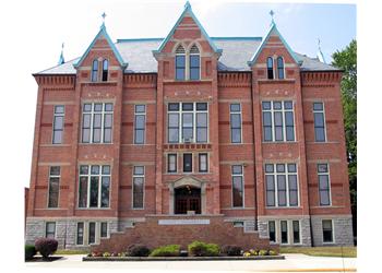 red-brick traditional academic building with arched windows