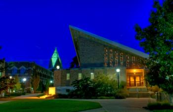 illuminated building at dusk on campus