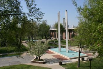 campus park with a pond and sculptures