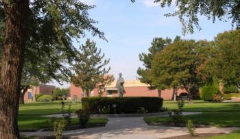 campus grounds with a statue and buildings